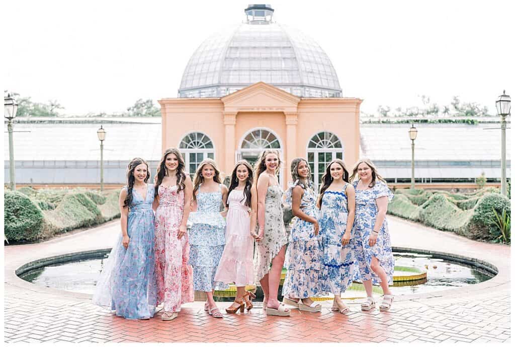 The JGP Senior model team group portrait in front of the New Orleans Botanical Garden conservatory.